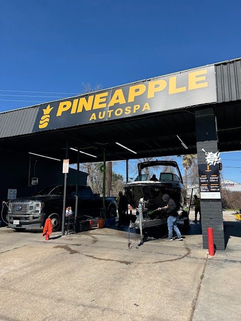 Boat and truck being washed at Pineapple Autospa North Houston — all vehicles welcome