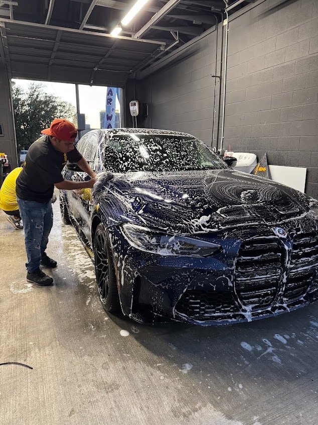 BMW M3 covered in soap during a hand wash at Pineapple Autospa, Houston